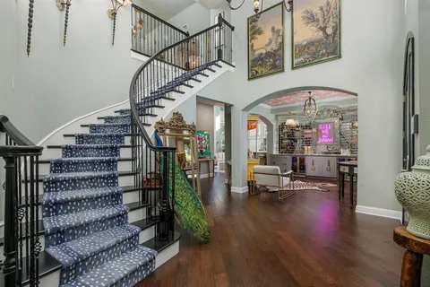 a view of entryway and hall with wooden floor