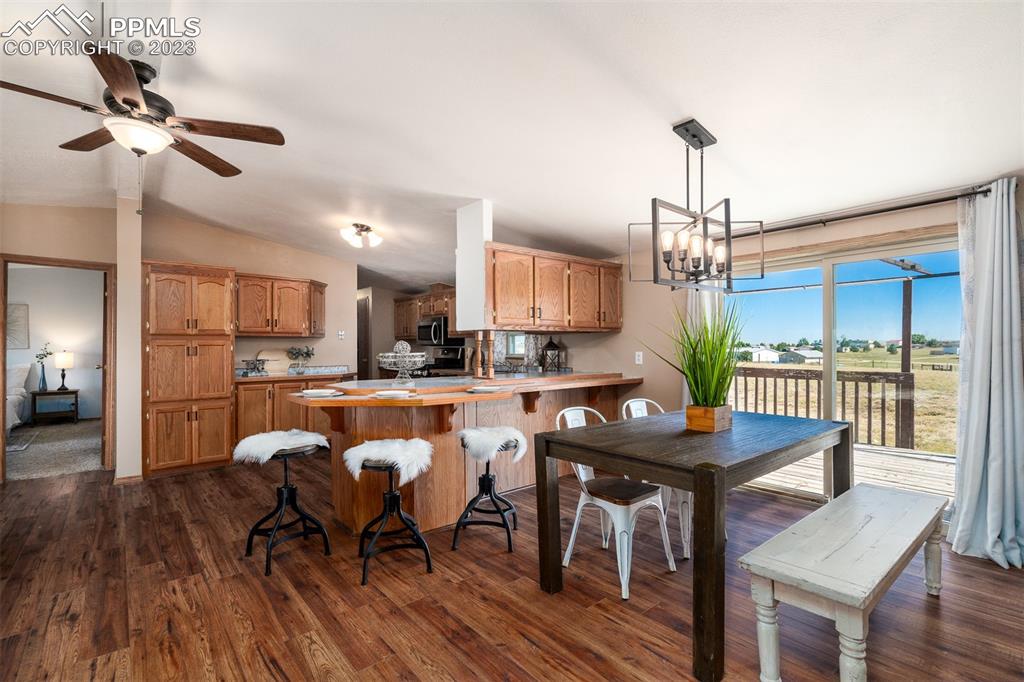 5695 Peerless Farms Road Peyton, CO 80831 - Photo 13 of 50 a view of a dining room with furniture window and wooden floor
