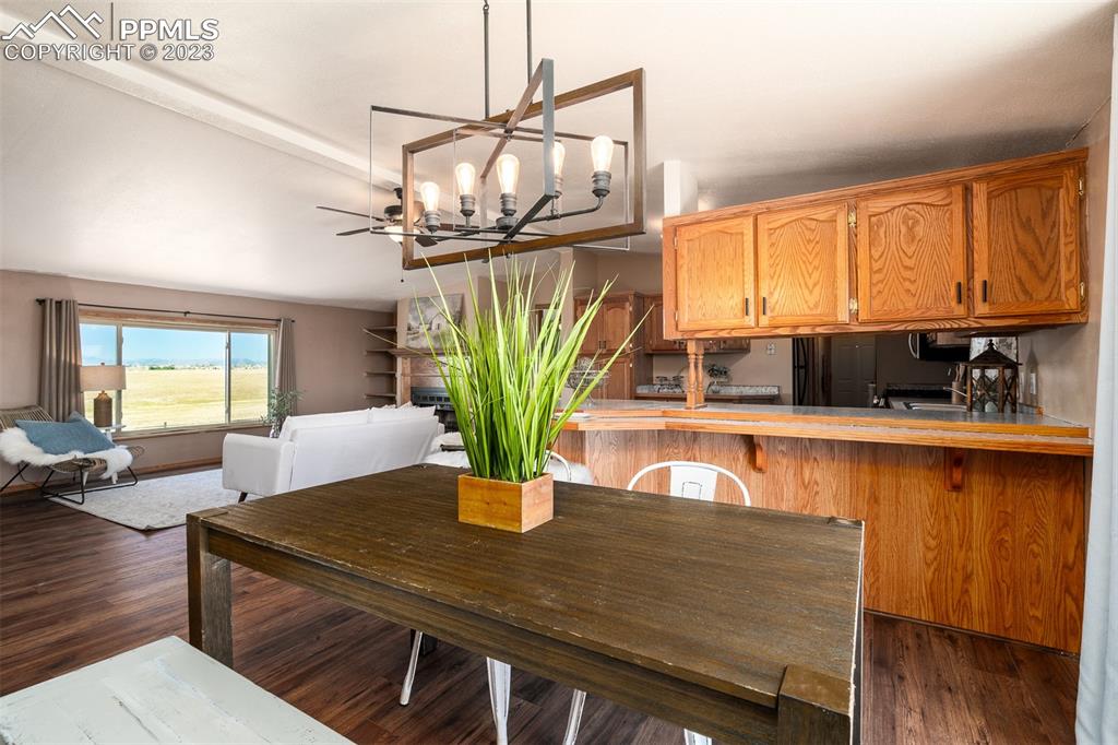 5695 Peerless Farms Road Peyton, CO 80831 - Photo 14 of 50 a view of a dining room with furniture window and wooden floor