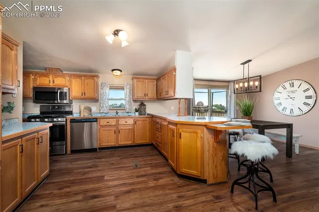 a kitchen with stainless steel appliances granite countertop a stove a sink dishwasher a microwave oven with granite countertops and cabinets