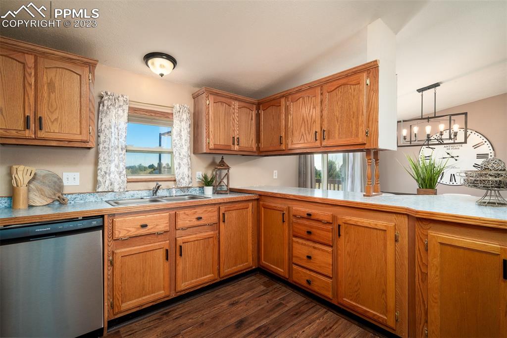 5695 Peerless Farms Road Peyton, CO 80831 - Photo 20 of 50 a kitchen with wooden cabinets and sink