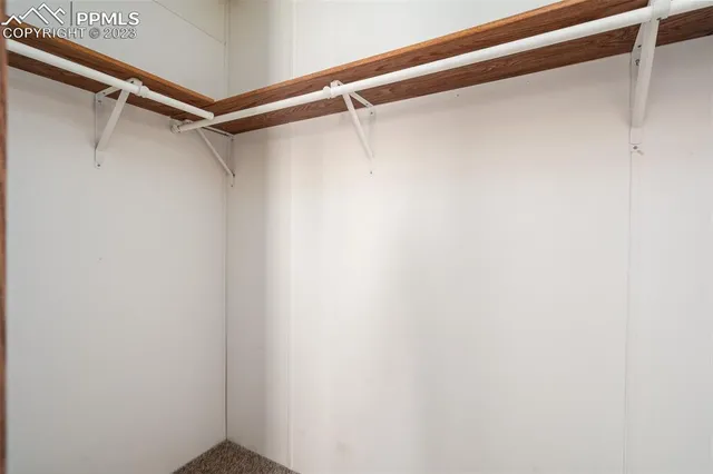 a room with lots of wooden furniture and a shower