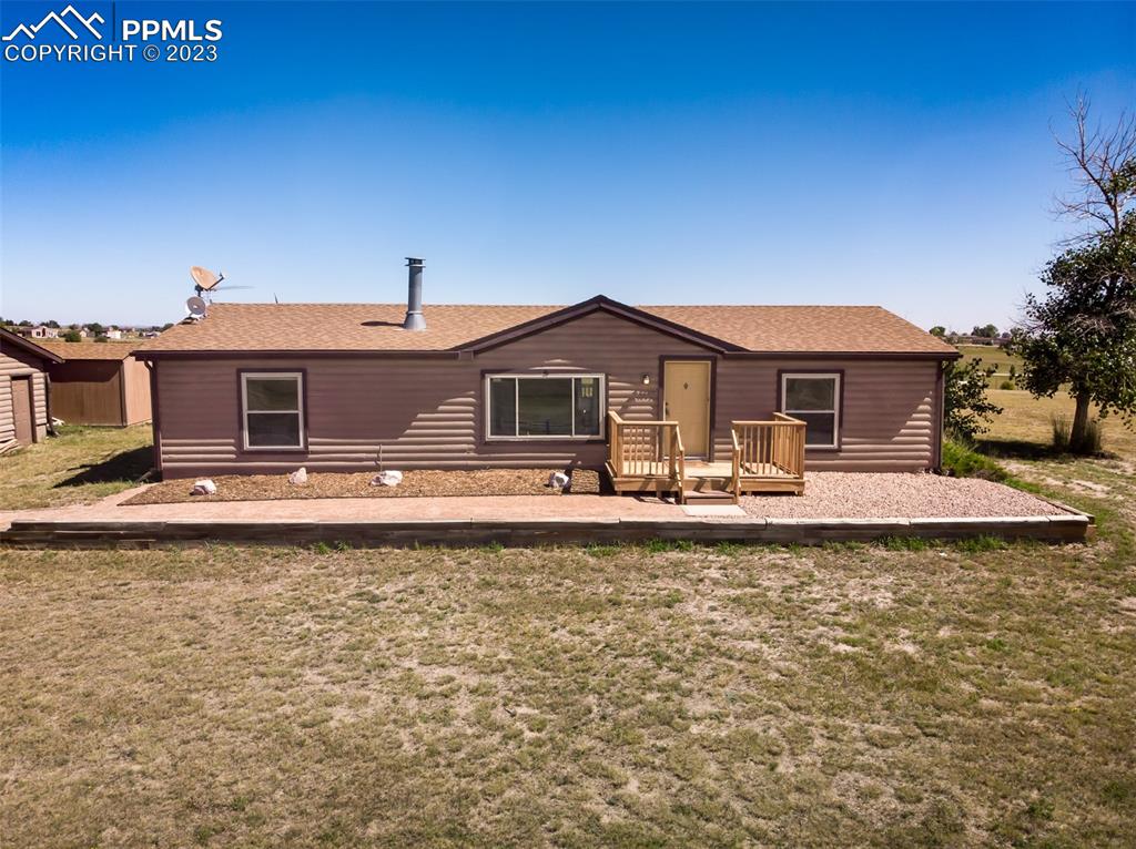 5695 Peerless Farms Road Peyton, CO 80831 - Photo 36 of 50 a front view of a house with garden