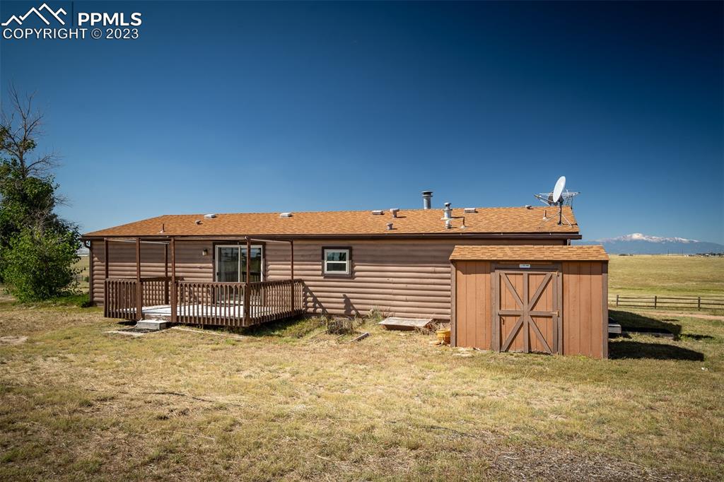 5695 Peerless Farms Road Peyton, CO 80831 - Photo 39 of 50 a view of a house with a wooden fence