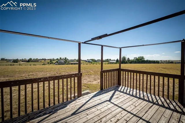 a tall house with a large tree in front of it