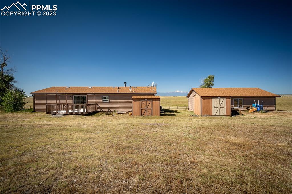 5695 Peerless Farms Road Peyton, CO 80831 - Photo 41 of 50 a tall house with a large tree in front of it