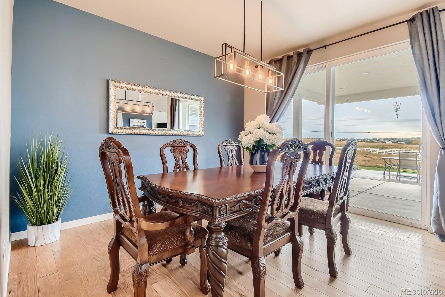 16035 Newark Lane Brighton, CO 80602 - Photo 15 of 40 a view of a dining room with furniture window and wooden floor
