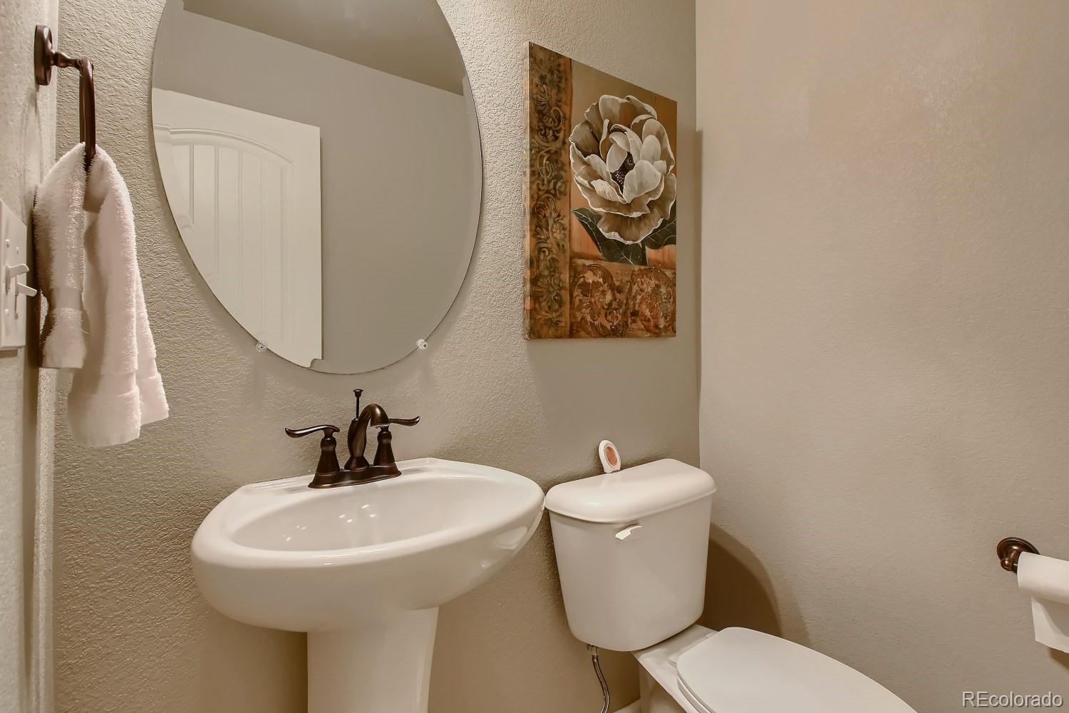 16035 Newark Lane Brighton, CO 80602 - Photo 16 of 40 a bathroom with a toilet and sink