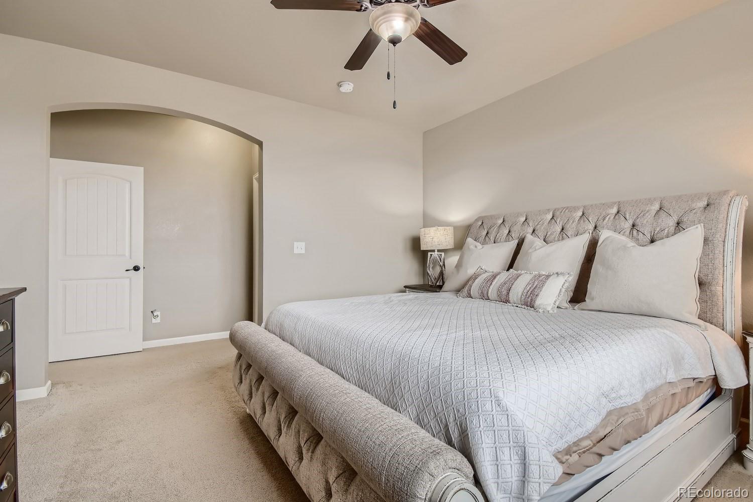 16035 Newark Lane Brighton, CO 80602 - Photo 19 of 40 a bedroom with a bed and painting on the wall