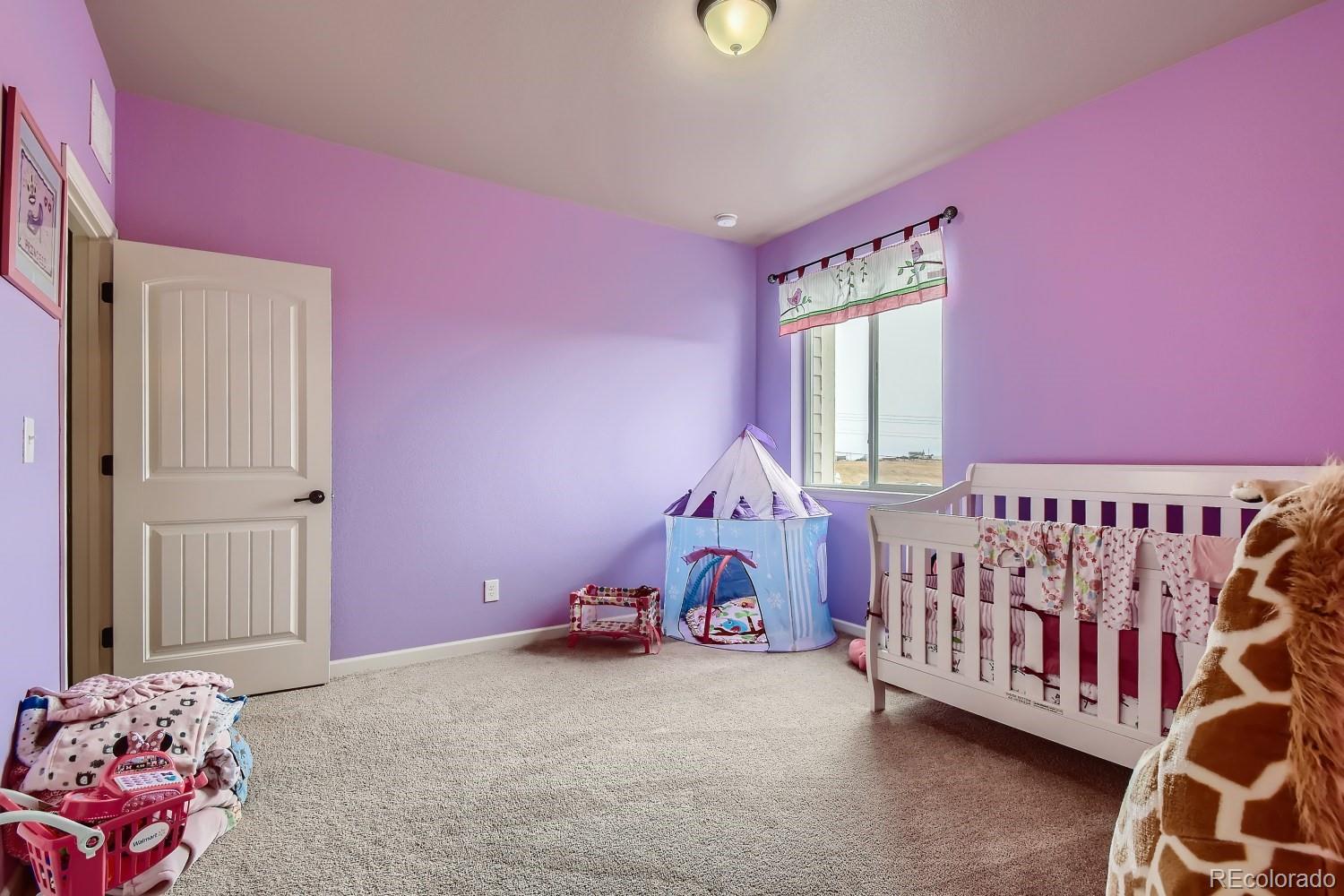16035 Newark Lane Brighton, CO 80602 - Photo 27 of 40 a bedroom with furniture and a window