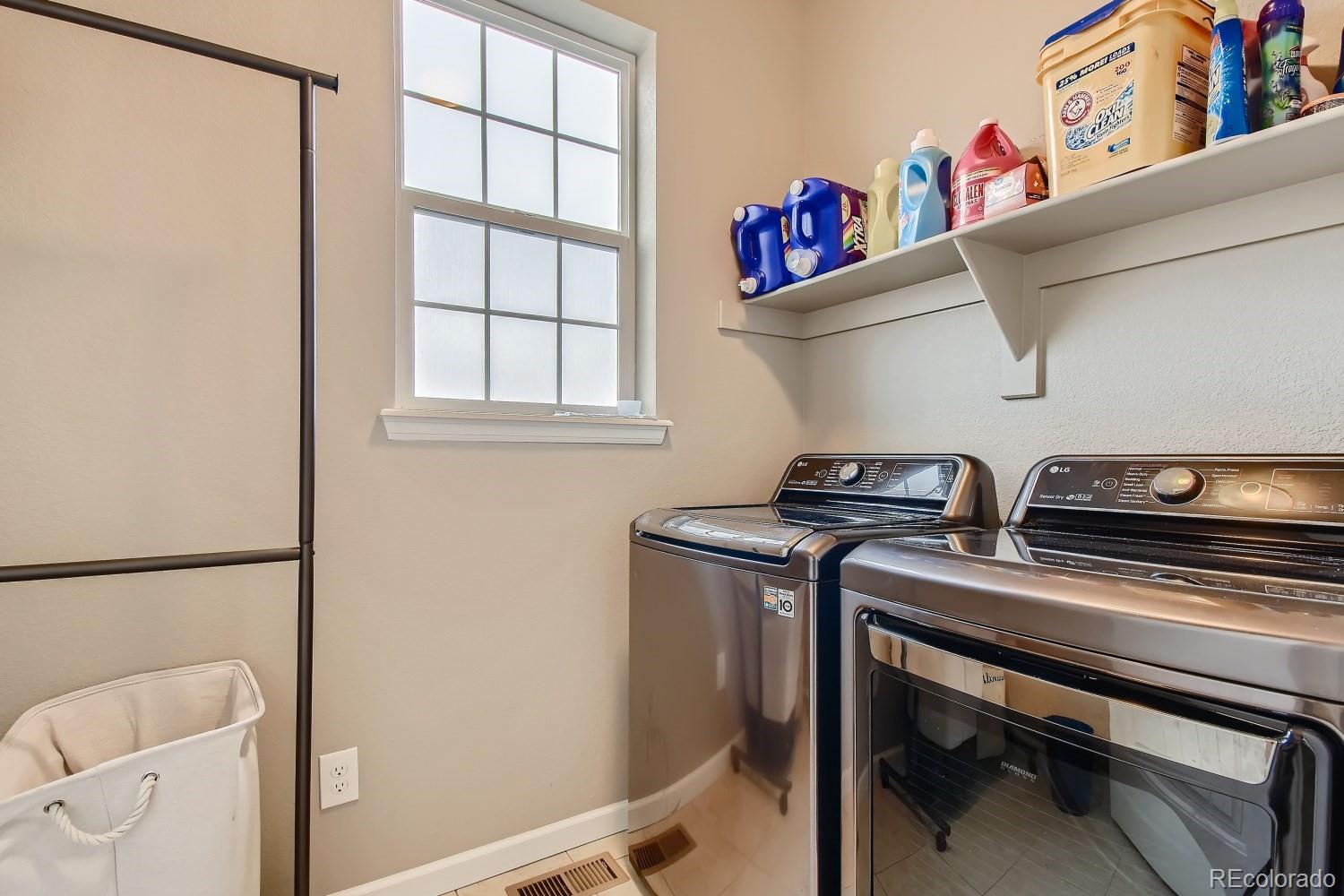 16035 Newark Lane Brighton, CO 80602 - Photo 29 of 40 a utility room with dryer washer and a window