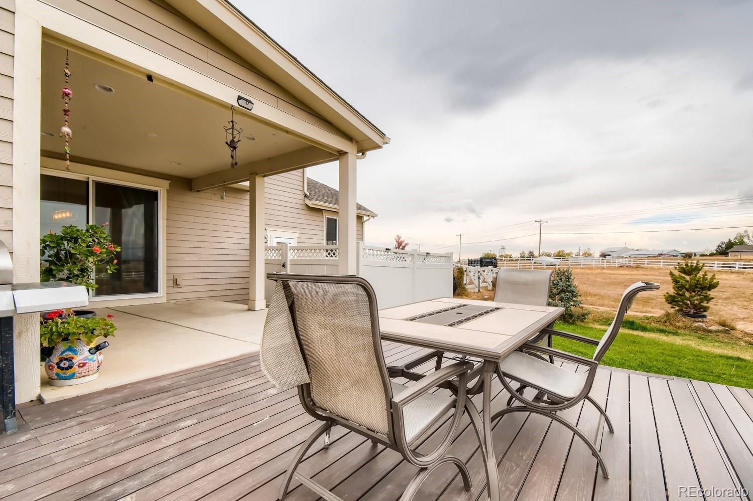 16035 Newark Lane Brighton, CO 80602 - Photo 33 of 40 a view of a roof deck with chair and wooden floor