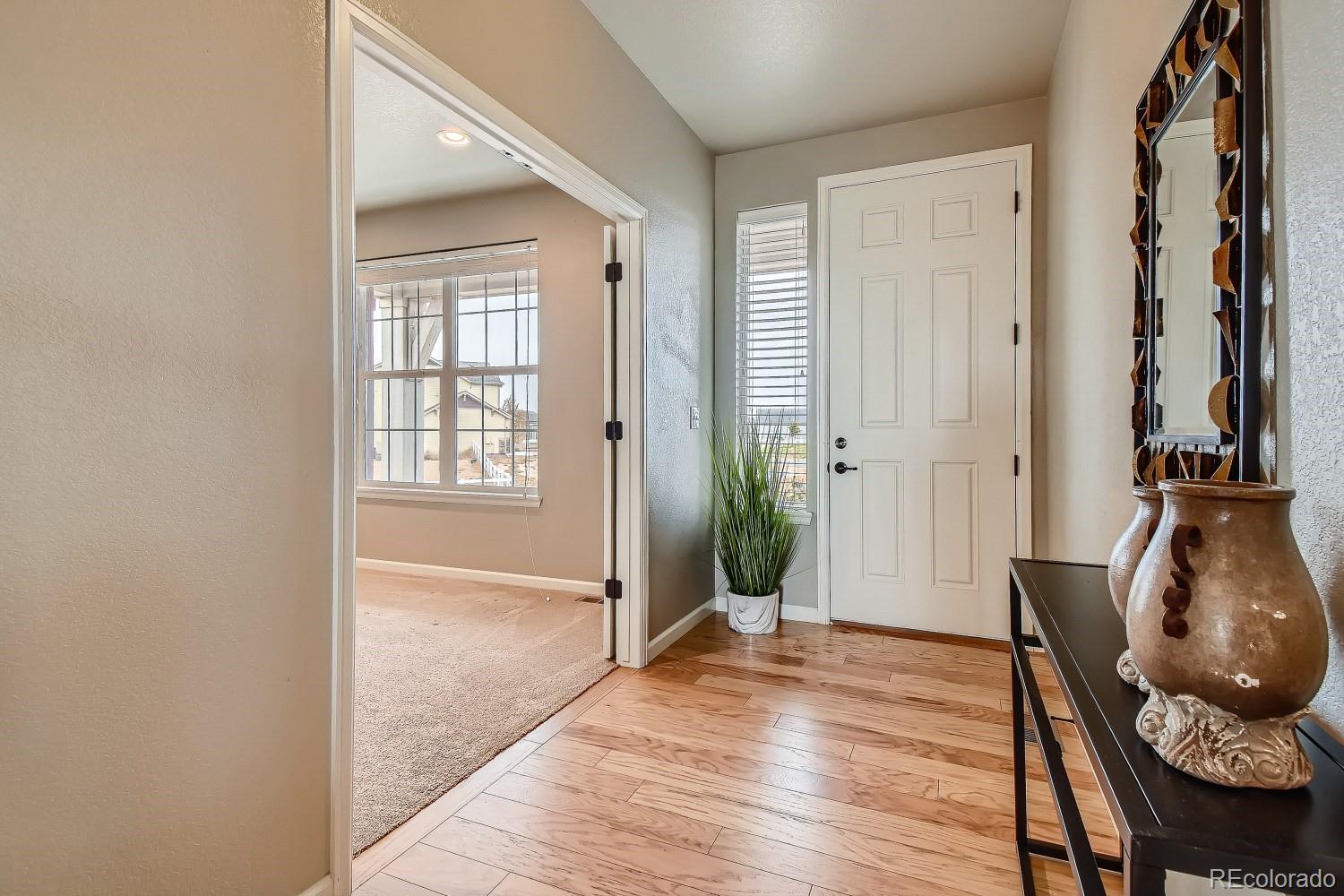 16035 Newark Lane Brighton, CO 80602 - Photo 6 of 40 a view of livingroom with furniture and wooden floor