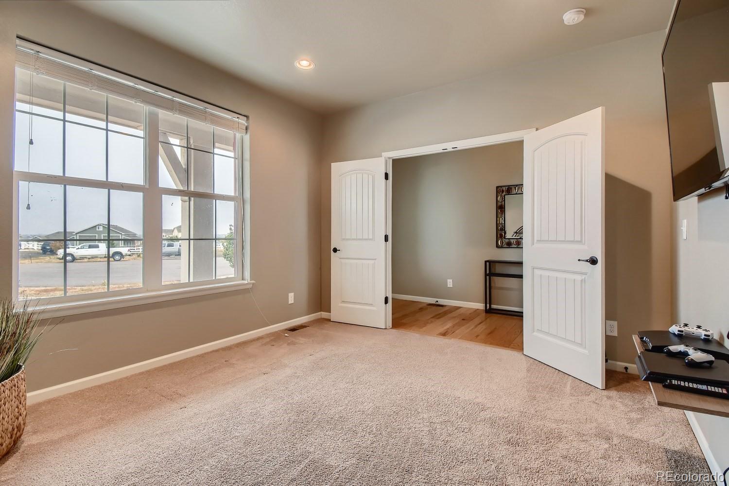 16035 Newark Lane Brighton, CO 80602 - Photo 8 of 40 a view of an empty room with a window