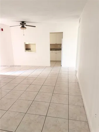 a view of a room with an empty space and a window
