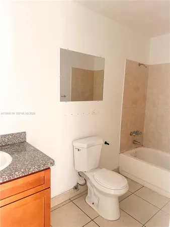 a bathroom with a granite countertop toilet a sink and bathtub