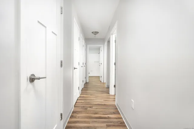 a view of a hallway with wooden floor