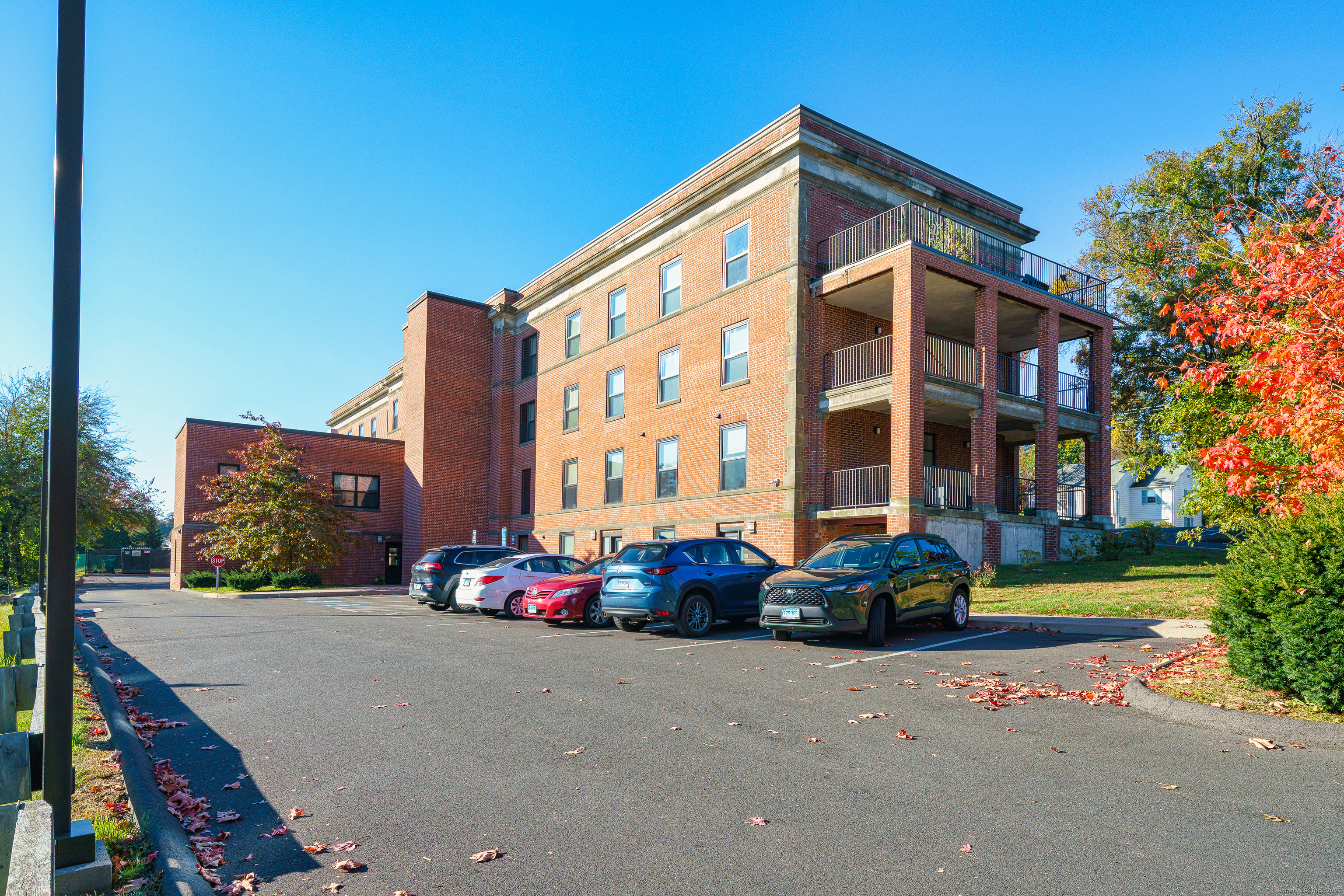 170 Ridge Road, Unit 104 Wethersfield, CT 06109 - Photo 21 of 23 a front view of multi story residential apartment building with yard