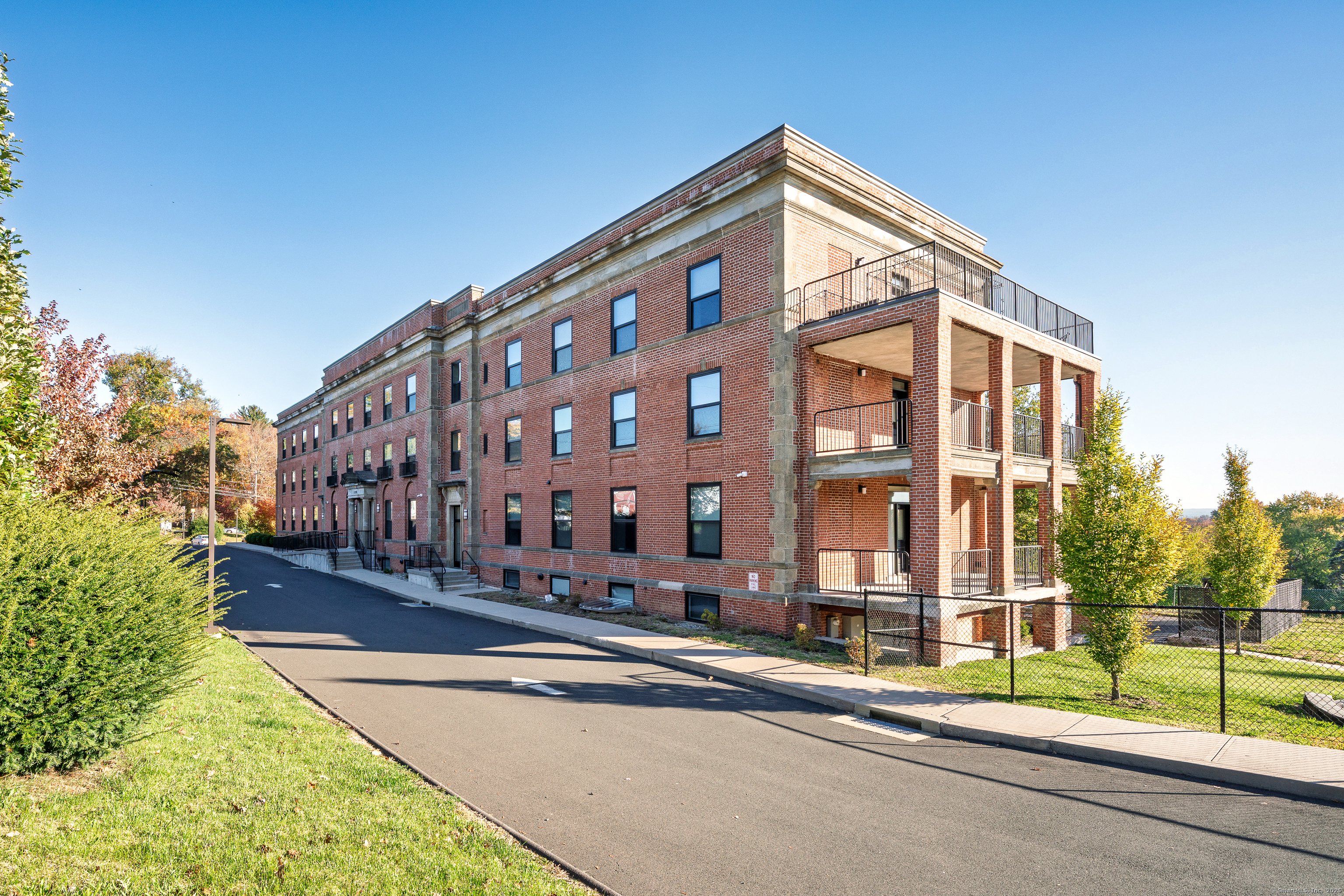 170 Ridge Road, Unit 104 Wethersfield, CT 06109 - Photo 4 of 23 a view of a tall building next to a road