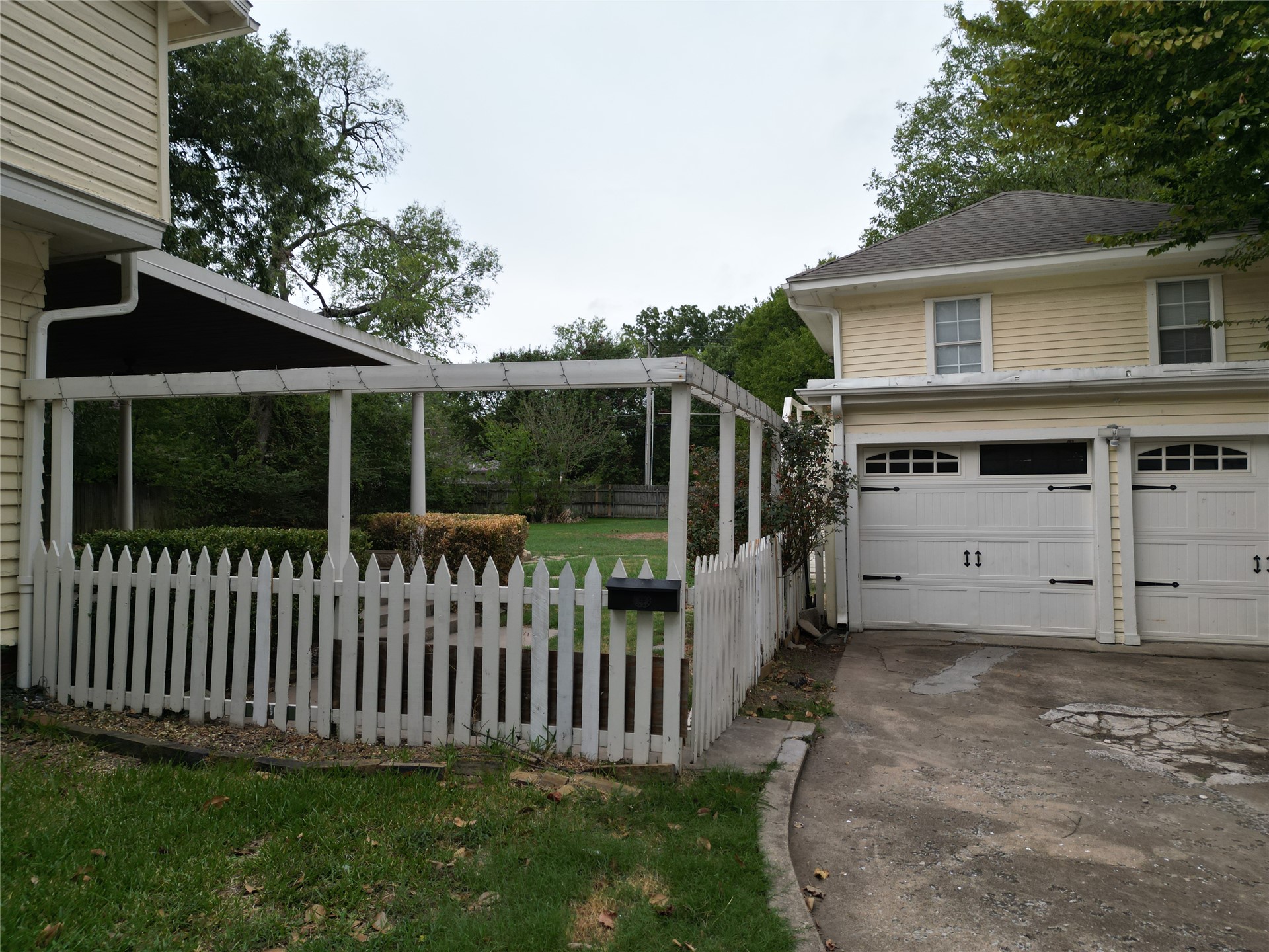 219 F Street Southwest Ardmore, OK 73401 - Photo 57 of 58 Attached two-car garage with overhead doors featuring decorative hardware
