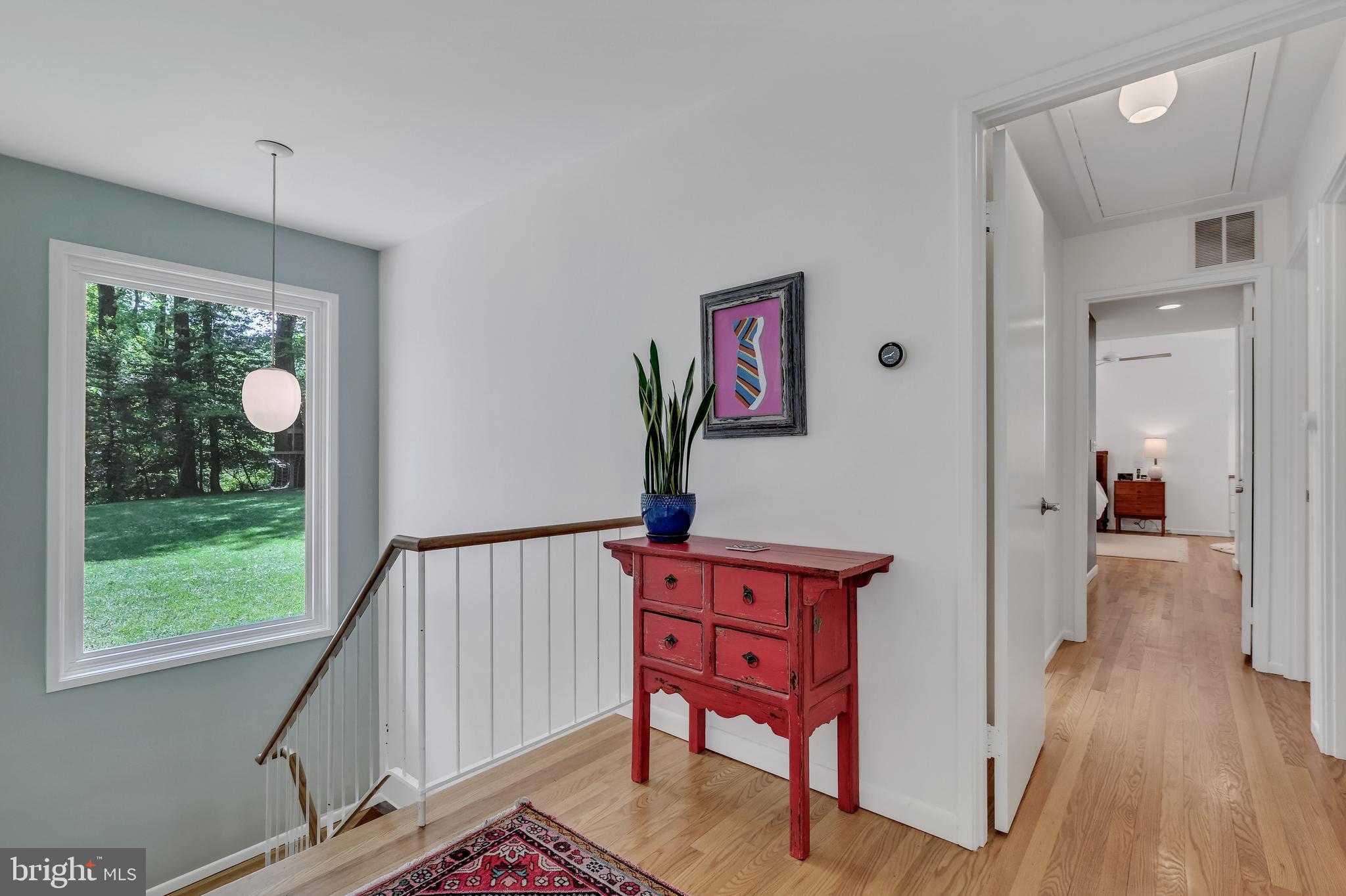 8303 Still Spring Court Bethesda, MD 20817 - Photo 15 of 56 a view of a hallway with wooden floor and windows