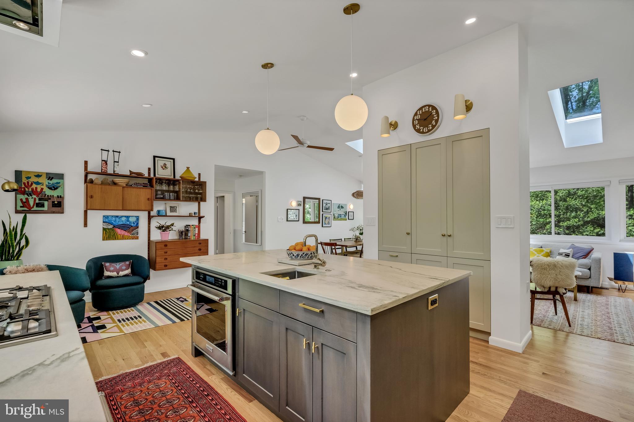 8303 Still Spring Court Bethesda, MD 20817 - Photo 20 of 56 a kitchen with a sink a stove a dining table and chairs
