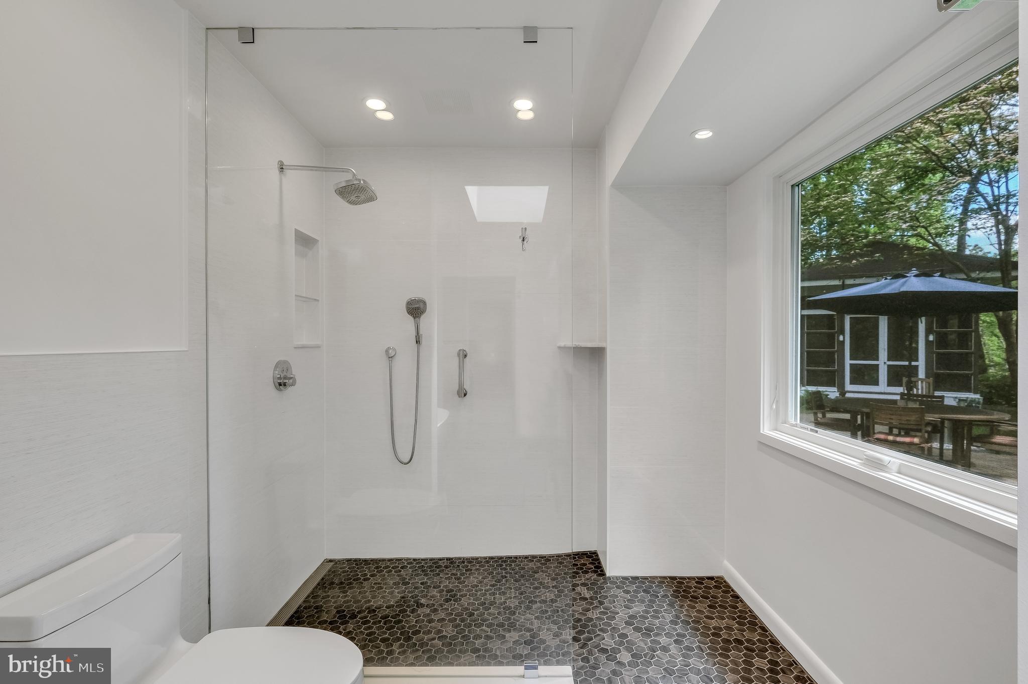 8303 Still Spring Court Bethesda, MD 20817 - Photo 30 of 56 a bathroom with a granite countertop sink a toilet a window and shower