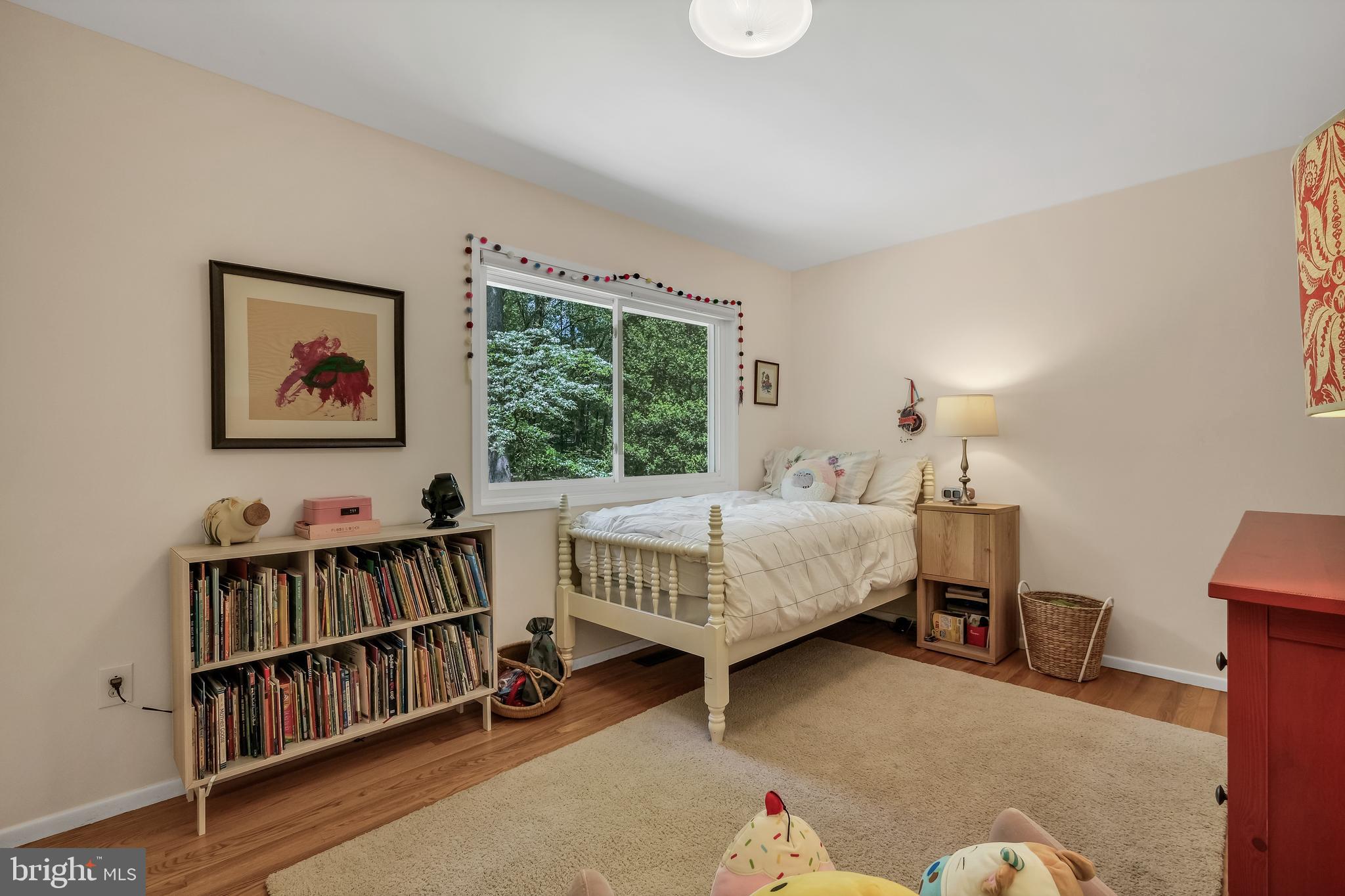 8303 Still Spring Court Bethesda, MD 20817 - Photo 34 of 56 a bedroom with a bed book shelf and a window