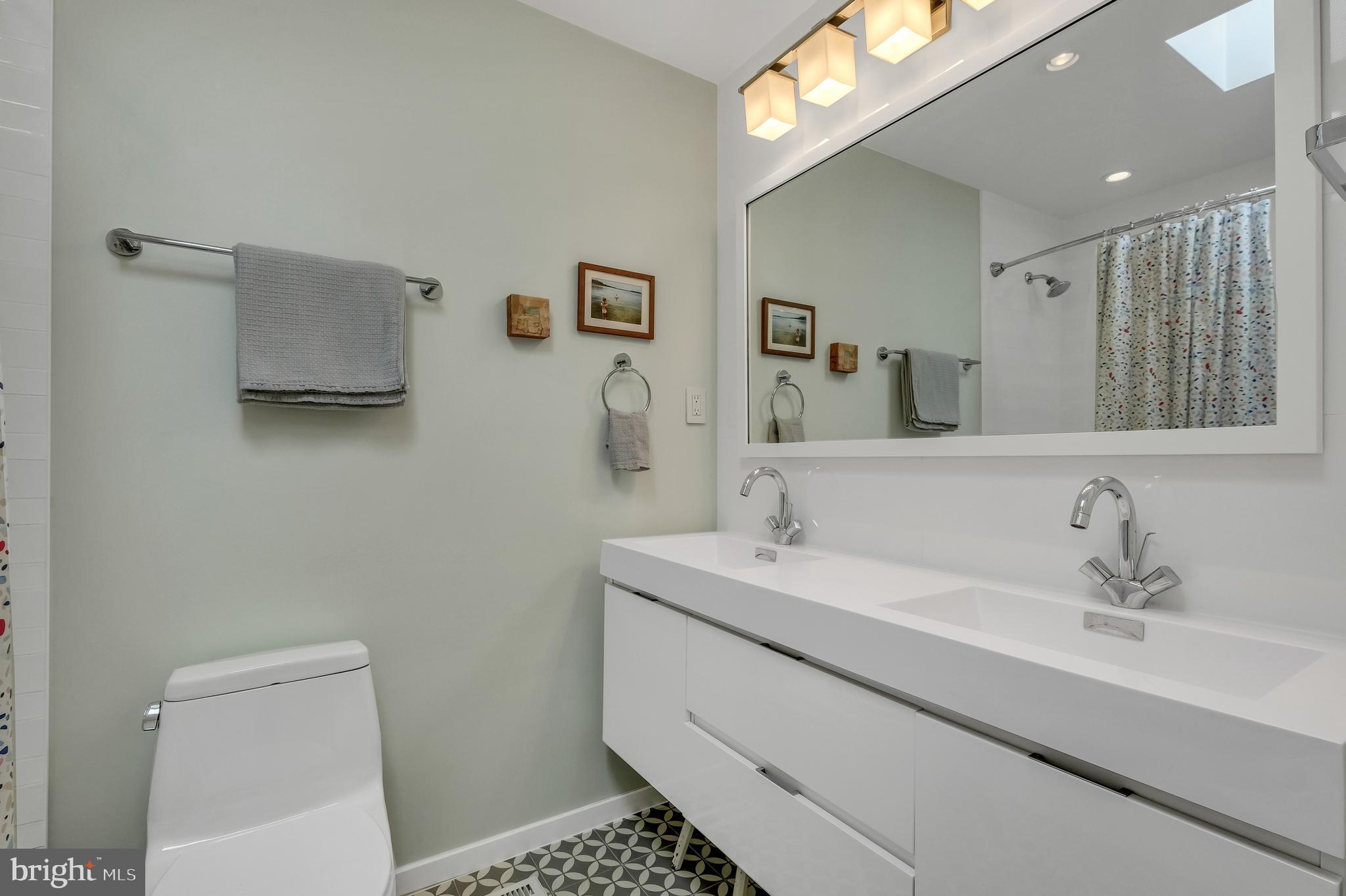 8303 Still Spring Court Bethesda, MD 20817 - Photo 37 of 56 a bathroom with a sink toilet and a mirror