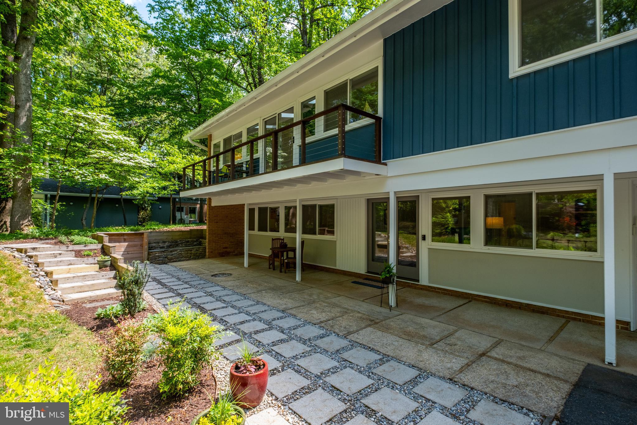 8303 Still Spring Court Bethesda, MD 20817 - Photo 7 of 56 a front view of a house with a garden
