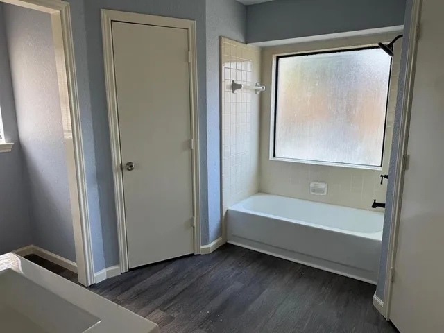 a bathroom with a bathtub and a shower