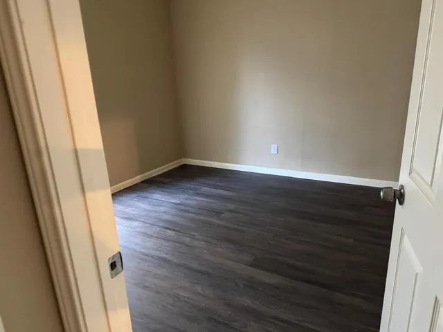 a view of an empty room and wooden floor