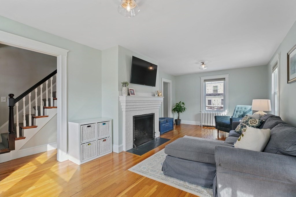 1 Brae Burn Road Milton, MA 02186 - Photo 3 of 16 a living room with furniture a flat screen tv and a fireplace