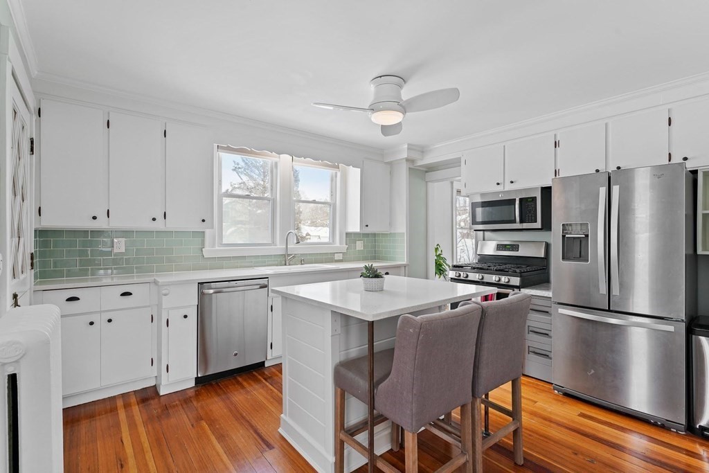1 Brae Burn Road Milton, MA 02186 - Photo 5 of 16 a kitchen with stainless steel appliances granite countertop a refrigerator a sink dishwasher a stove and white countertops with wooden floor