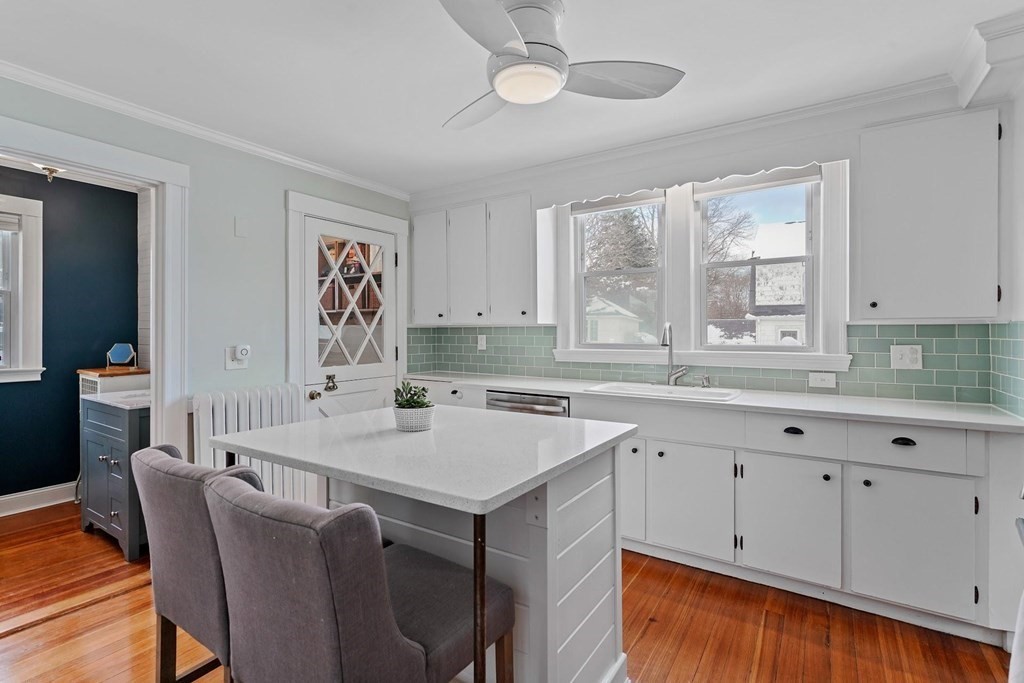 1 Brae Burn Road Milton, MA 02186 - Photo 6 of 16 a kitchen with a stove a sink a dining table and chairs