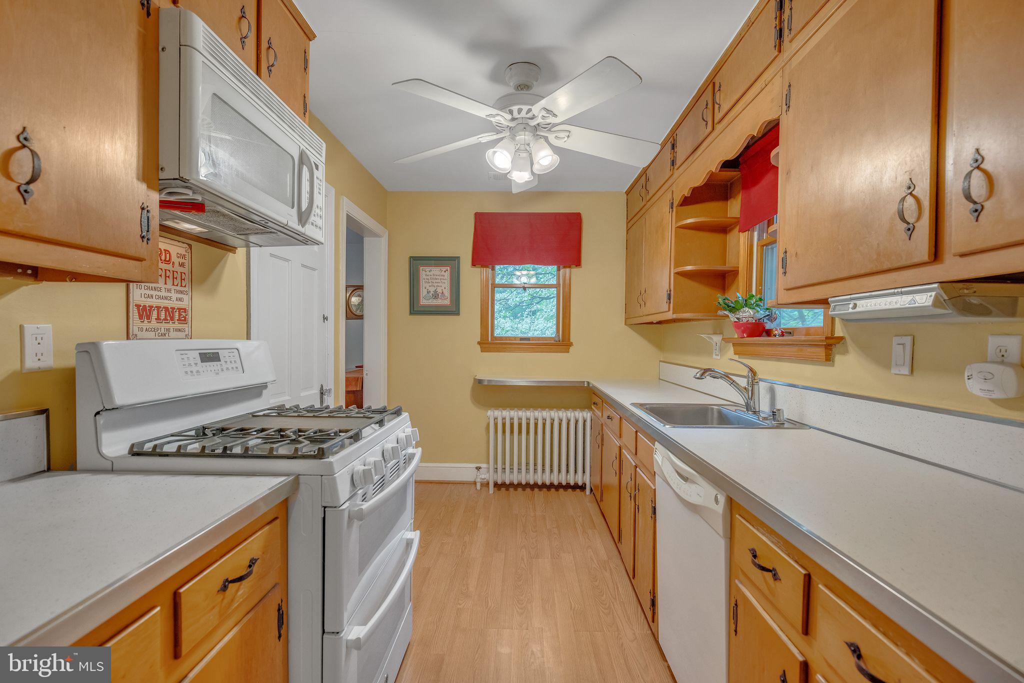 2206 Briggs Chaney Road Silver Spring, MD 20905 - Photo 6 of 40 a kitchen with stainless steel appliances granite countertop a sink stove and cabinets