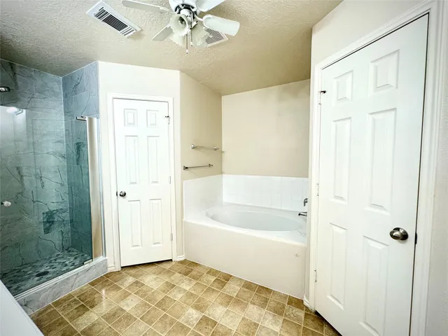 a bathroom with a bathtub and shower