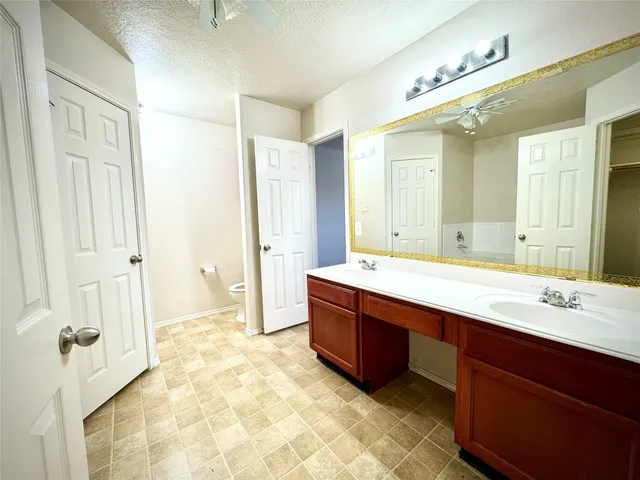 a bathroom with a tub sink and mirror