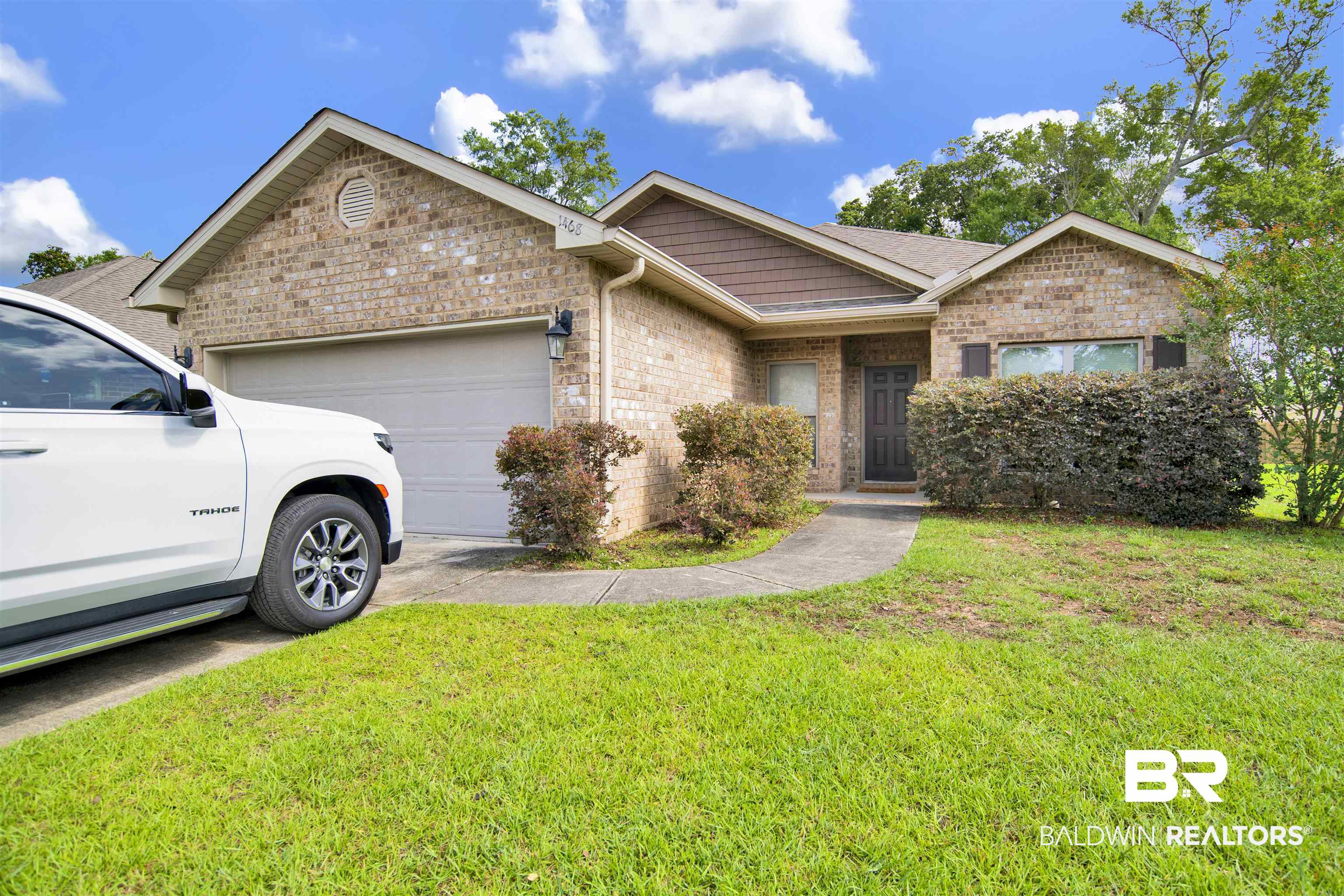 1468 Surrey Loop Foley, AL 36535 - Photo 1 of 28 Single story home featuring a garage, a front yard, and brick siding