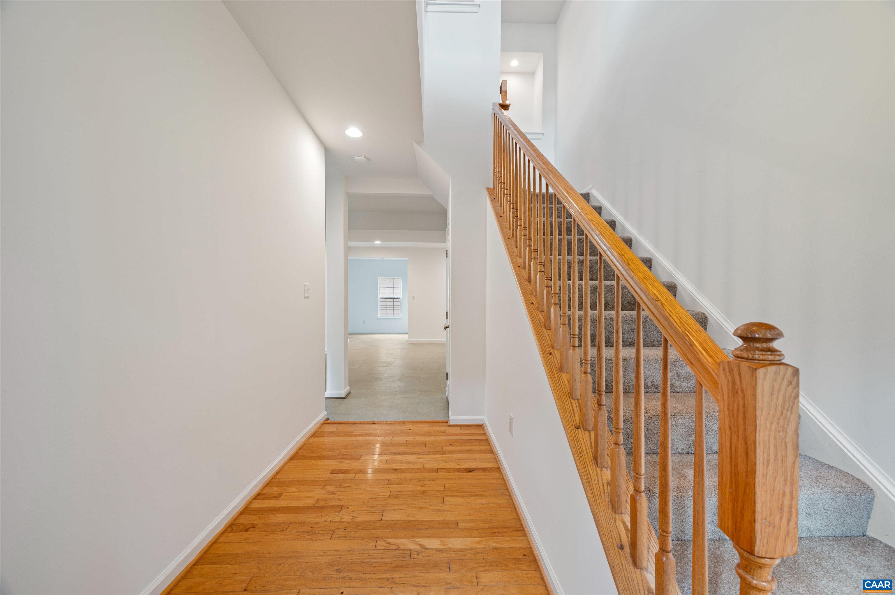 709 Rainier Road Charlottesville, VA 22903 - Photo 3 of 53 a view of a hallway with wooden floor and stairs