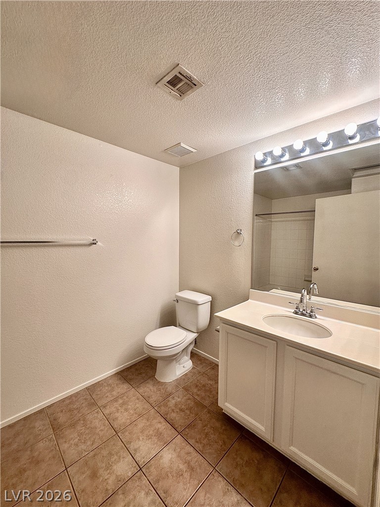 2053 Turquoise Ridge Street, Unit 202 Las Vegas, NV 89117 - Photo 11 of 18 A classic vanity setup and neutral tile floors define this functional bathroom space.