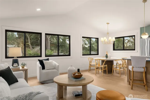 a kitchen with a table chairs stove and cabinets