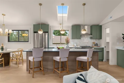 a living room with furniture a fireplace and a potted plant