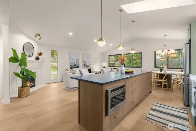 a kitchen with a sink and chairs