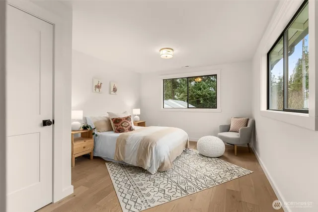 a bathroom with a sink a toilet a mirror a vanity and bathtub