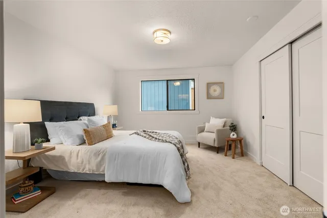 a bedroom with a bed and a potted plant