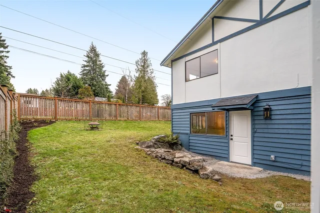 a view of a house with a yard and sitting area