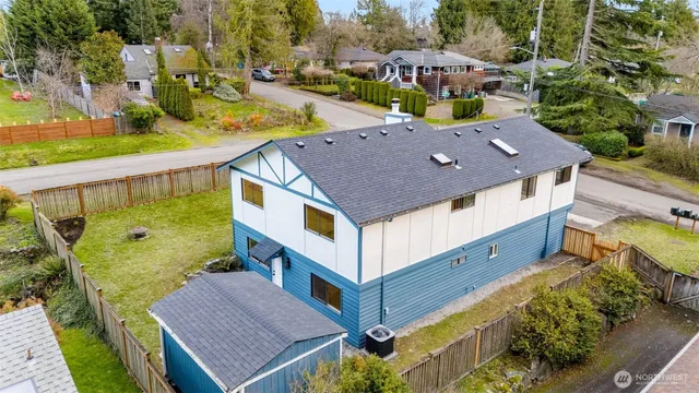an aerial view of a house with a yard