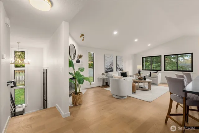 a living room with fireplace furniture and a large window