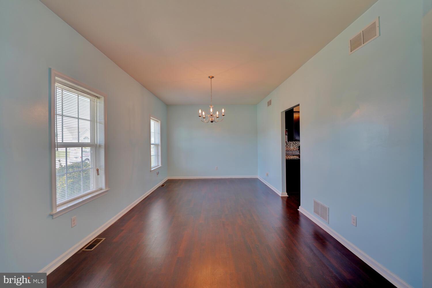 167 Spring Dale Lane Felton, DE 19943 - Photo 11 of 54 an empty room with wooden floor and windows